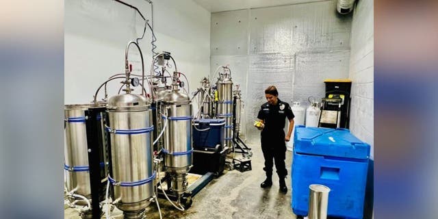 LAPD officer next to vat used for drugs