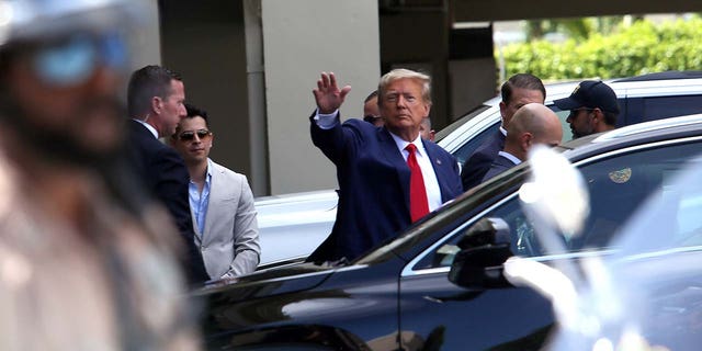 Former U.S. President Donald Trump waves as he makes a visit to the Cuban restaurant Versailles