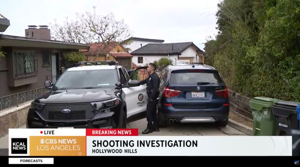 Police and investigators are seen parked up by the house where Emil Lahaziel died. 