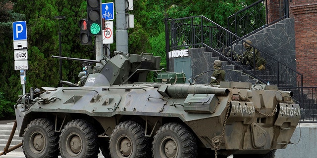 An armoured personnel carrier parked in Rostov as Wagner group mercenaries patrol the area