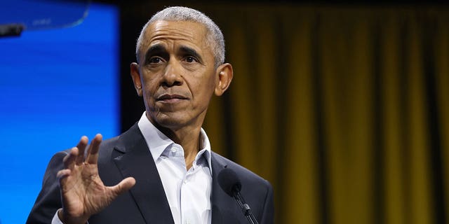 Barack Obama holds his hand up during election event