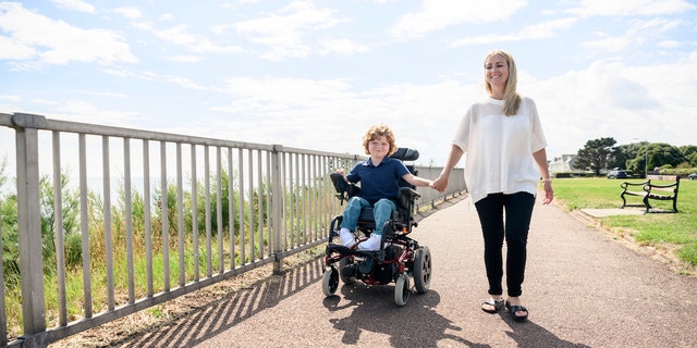 Boy in wheelchair with mom