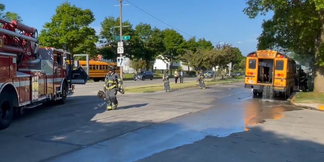 Fire truck next to bus that was on fire