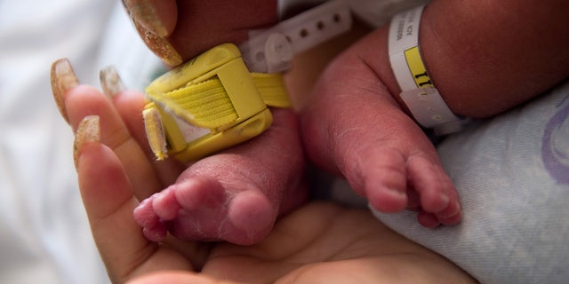 Close up of a mother holding her baby in the hospital