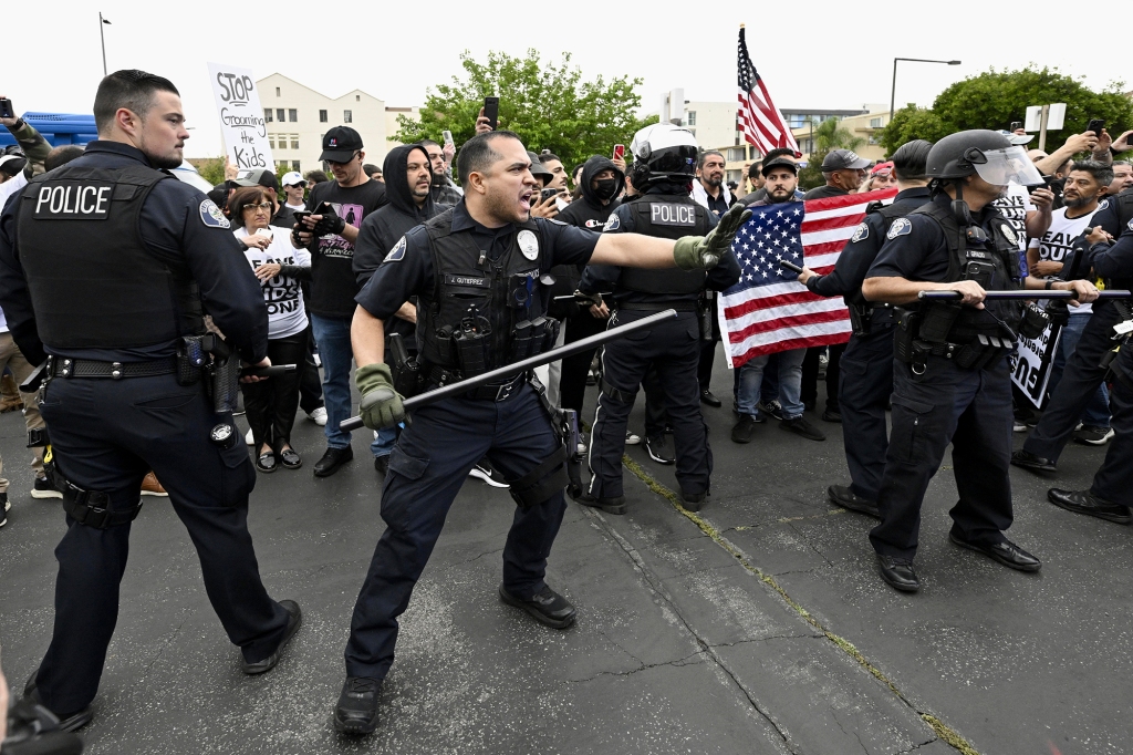 Cops attempt to stop the chaos between the two groups on June 6, 2023.