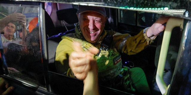 Wagner Group chief Yevgeny Prigozhin greets bystanders as he leaves Rostov following his short-lived rebellion