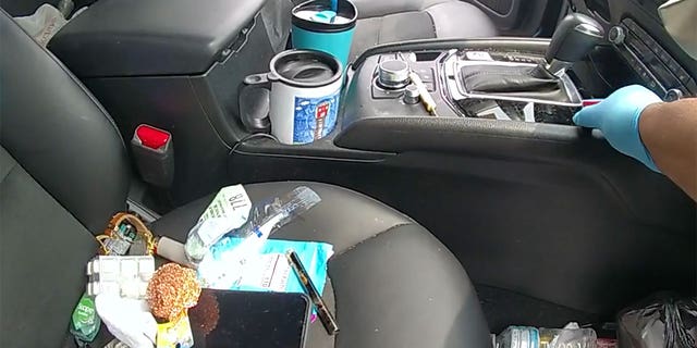 The passenger seat in Reilly's vehicle is covered in trash