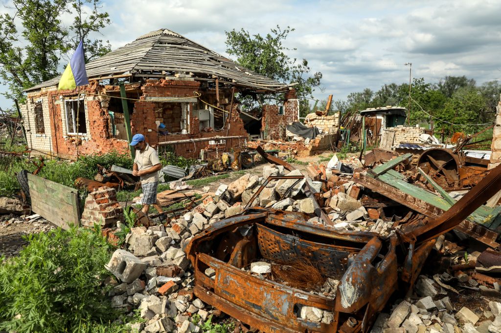 A woman walks near the remains from his house, damaged during active combat action, in Dovhenke village, Kharkiv region, 29 May 2023 (issued 30 May 2023). Valeriy evacuated from his home on 17 March 17 2022. Soon after the liberation of the Kharkiv region he moved to Izium. He set up a temporary temporary house and now tries to manage with his destroyed property. Russian troops entered Ukraine on 24 February 2022 starting a conflict that has provoked destruction and a humanitarian crisis.