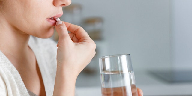 Woman taking pill