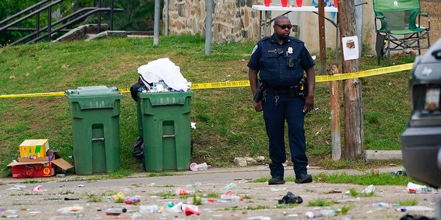 Trash cans, police officer