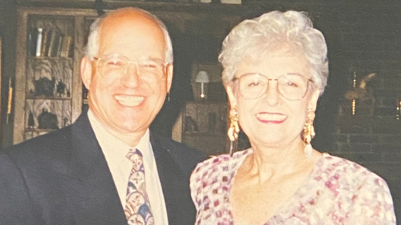 Taw Benderly in a suit and tie next to Loretta Bowersock in a colorful dress as they both smile