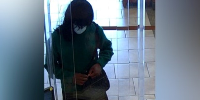 Suspect opening purse at bank