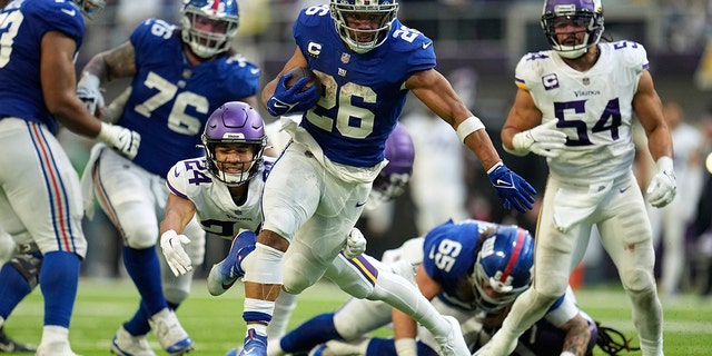 Saquon Barkley breaks a tackle