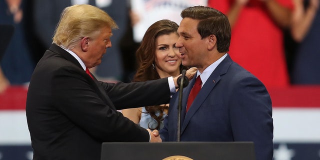 Donald Trump and Ron DeSantis shake hands