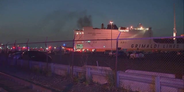 smoke rising from cargo ship