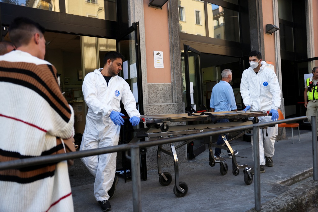 Emergency personnel are spotted working at the scene of the retirement home fire in Milan, Italy, on July 7, 2023. 