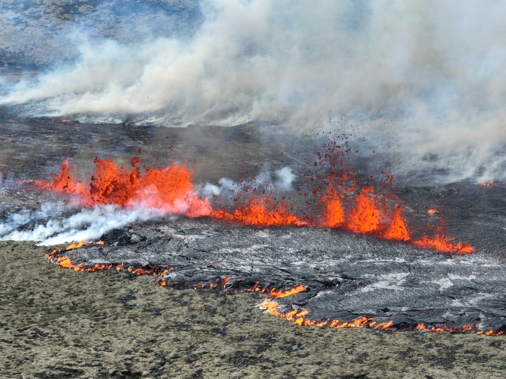 Smoke billows and lava spurts after the eruption of a volcano on the Reykjanes peninsula, near the capital Reykjavik, in southwest Iceland, on July 10, 2023. 