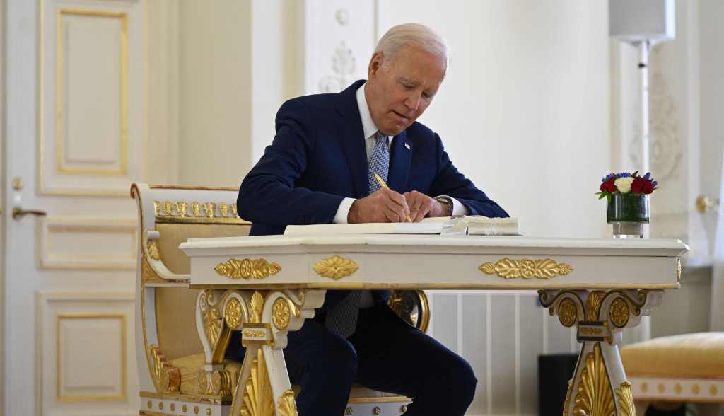 President Joe Biden signs the guest book during a bilateral meeting with Lithuania's President on the sidelines of a NATO Summit in Vilnius, Lithuania, on July 11, 2023. 