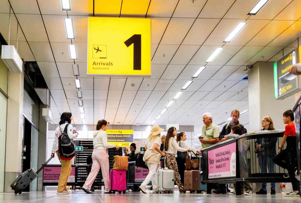 Travelers arrive after returning from the Greek island of Rhodes where evacuations are underway due to wildfires at the Schiphol airport on July 24, 2023. 