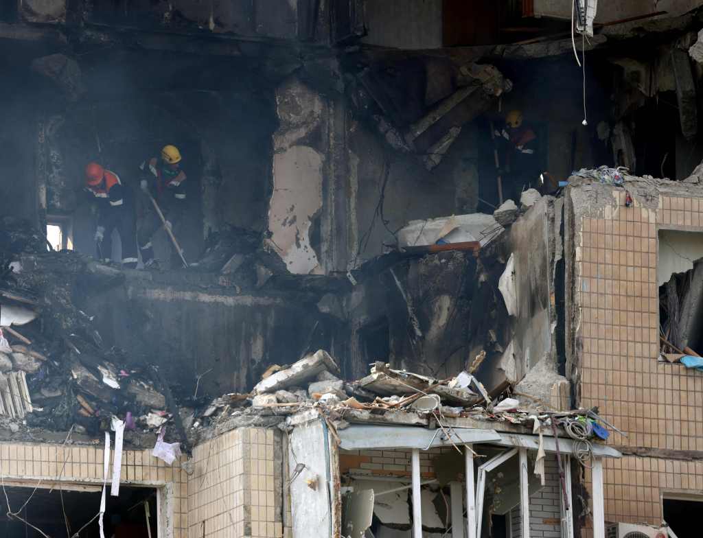 Rescuers work in a nine-storey residential building partially destroyed as a result of Russian missiles strike in Kryvyi Rig on July 31, 2023.