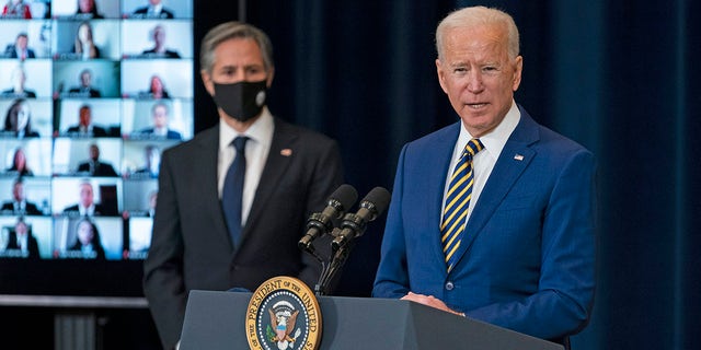 Secretary of State Antony Blinken listens as President Joe Biden delivers remarks to State Department staff, Thursday, Feb. 4, 2021, in Washington. (AP Photo/Evan Vucci)