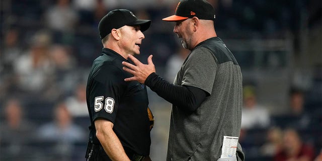 Brandon Hyde talks to the umpire after being ejected