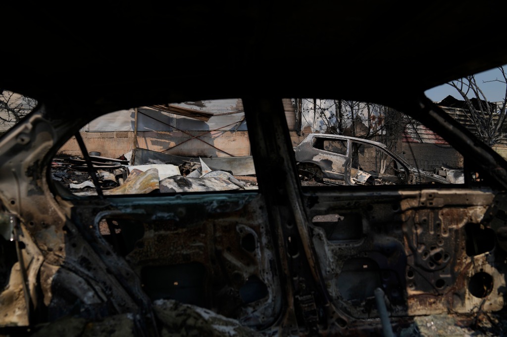 Burnt cars after yesterday's fire in Mandra west of Athens, on July 19, 2023. 