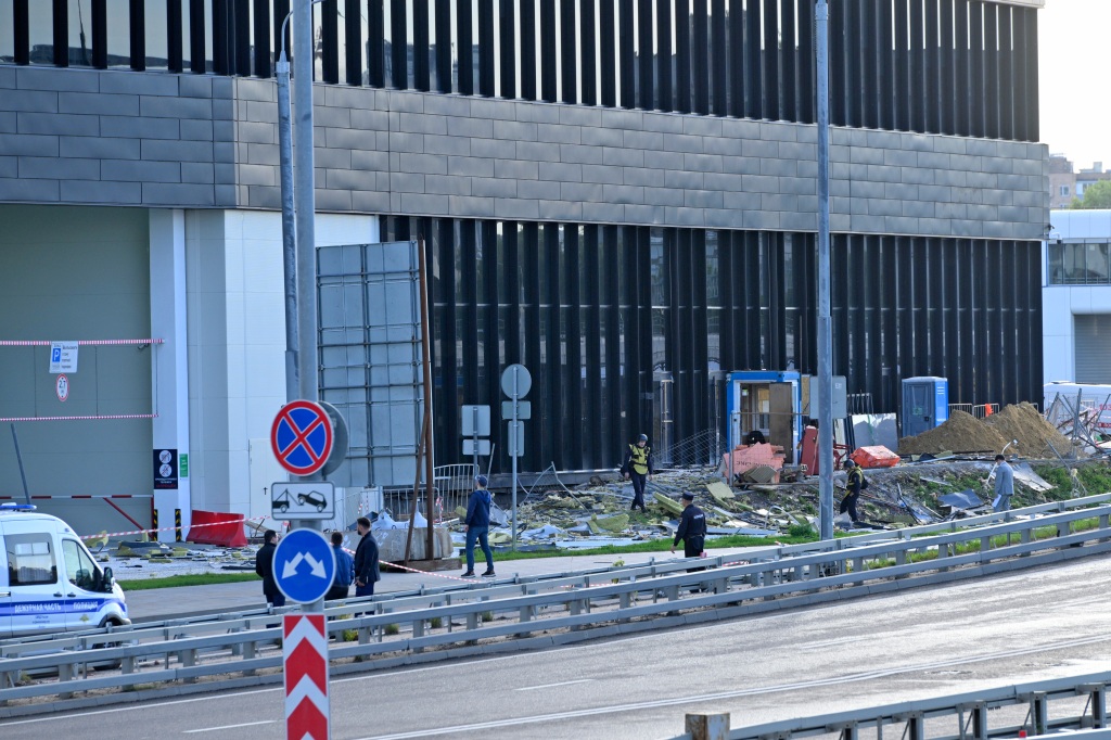 Investigators examine a damaged building after a reported drone attack in Moscow, Russia, on July 24, 2023. 