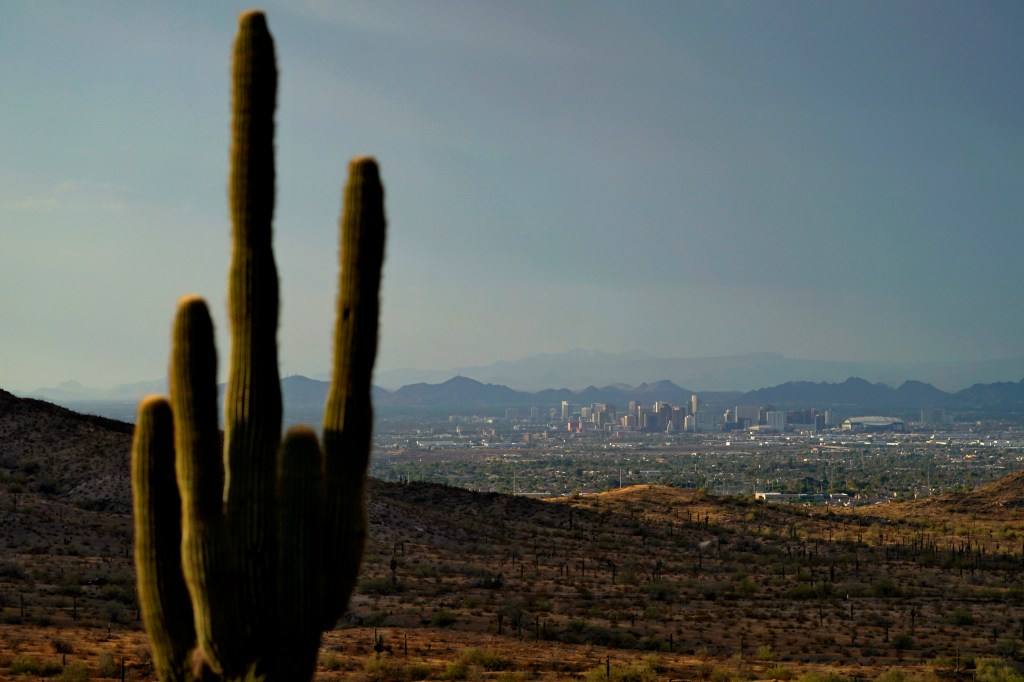 The sun sets over Phoenix amid a heat wave on July 30, 2023. 