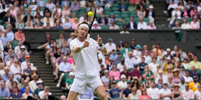 Andrey Rublev holds his racket