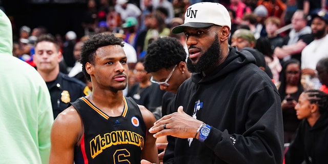 LeBron James talks with son, Bronny, on court