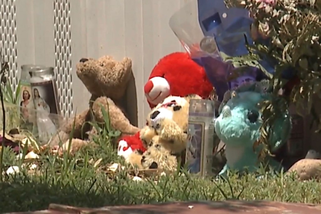 Flowers and stuffed animals are spotted near a makeshift memorial for 15-year-old Lily Silva-Lopez. 