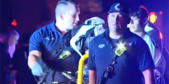 EMT taking person on a stretcher from El Paso, Texas house party shooting