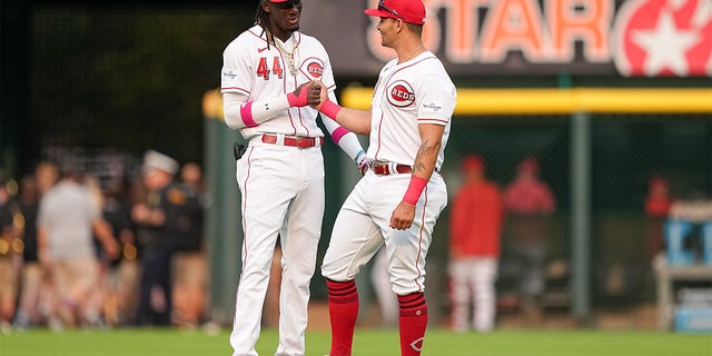 Elly De La Cruz and Christian Encarnacion-Strand shake hands