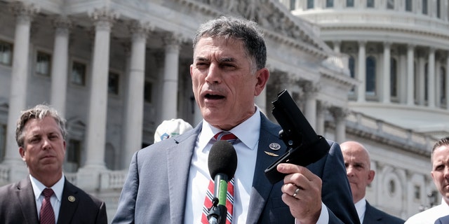 Rep. Andrew Clyde, R-Ga., holds a pistol brace as he speaks to the press during a press conference on Capitol Hill on June 13, 2023 in Washington, D.C.