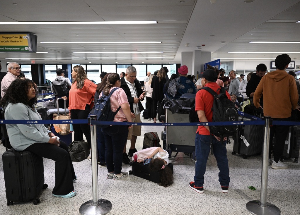 Passengers wait at the Newark Liberty International Airport as more than 2000 flights were canceled in New Jersey on June 27, 2023. 