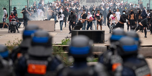 Protestors demonstrate in front of police