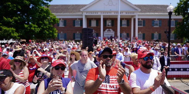 People clapping in front of the state house