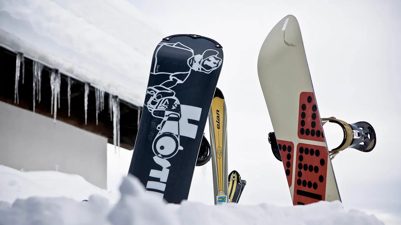 Snowboard And Ski In The Snow stuck in snow