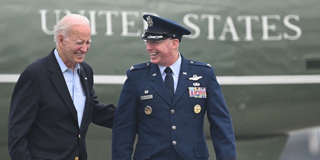 Biden walks to board Air Force One to depart for the UK