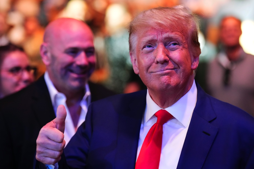 Trump gives a thumbs up to the crowd at T-Mobile Arena as Dana White looks on.