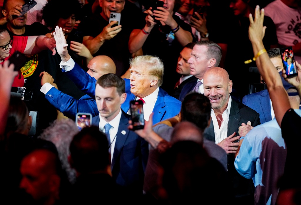 After publicly warning Biden that the "gloves are off," Trump went to a UFC match at the T-Mobile arena with longtime ally Roger Stone and controversial actor Mel Gibson. 