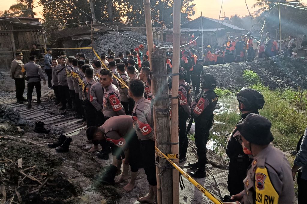 Police and rescue workers closed off an illegal gold mine site at Pancurendang village in Banyumas during a rescue operation for eight miners trapped underground on July 26, 2023. 