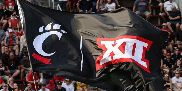 A Cincinnati Bearcats flag flies at a football game