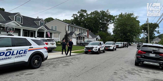 Suffolk County police stationed outside of a home