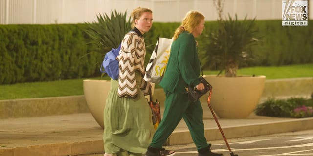 Rex Heuermann's wife, Asa Ellerup and daughter, Victoria Heuermann walk on the street