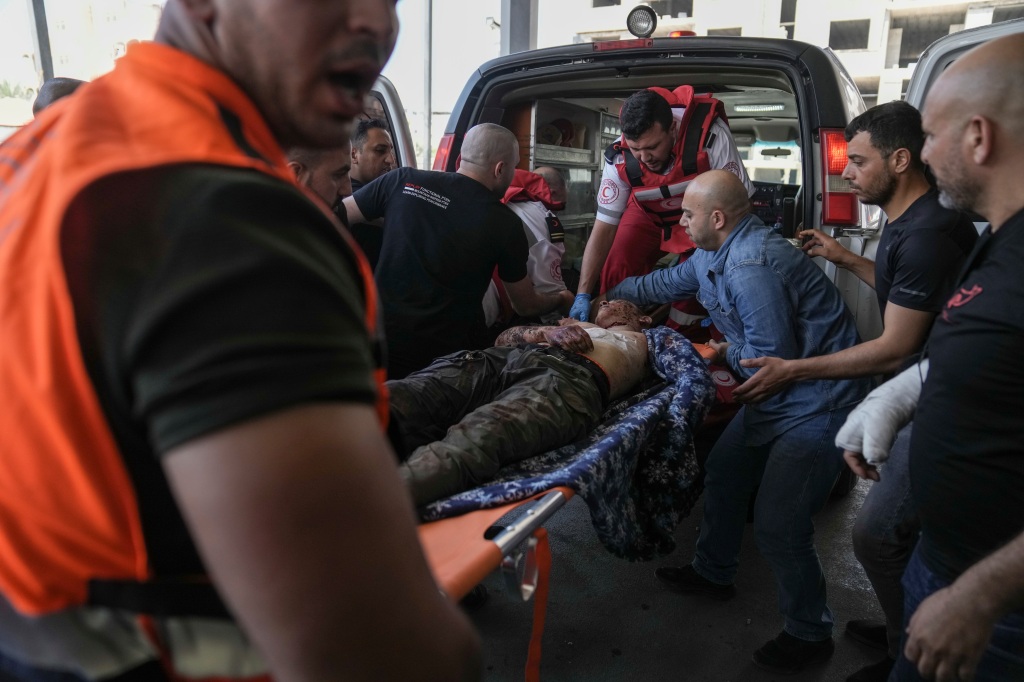 An injured Palestinian is carried into a hospital during an Israeli military raid in the Jenin refugee camp, a militant stronghold in the occupied West Bank, on July 3, 2023. 