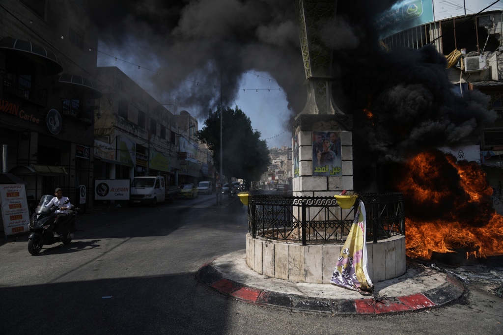 Tires burn during an Israeli military raid in the militant stronghold of Jenin refugee camp in the occupied West Bank, on July 3, 2023.