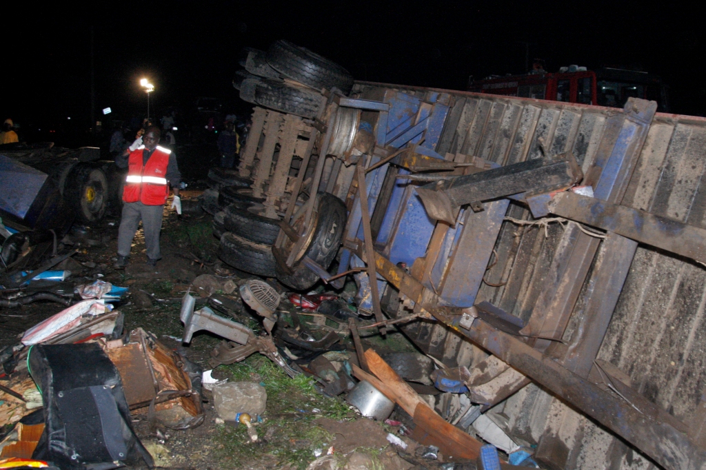 A truck can be seen flipped over on the ground after the fatal accident in Londiani, Kenya, on July 1, 2023. 