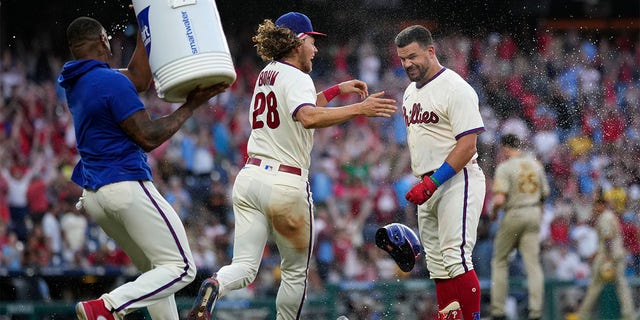 Kyle Schwarber celebrates with Alec Bohm